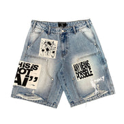 Denim shorts with text and graphic designs on a white background