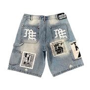 Denim shorts with patches and branding on a white background