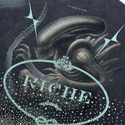 T-shirt with alien graphic and 'Riche' branding on a dark background
