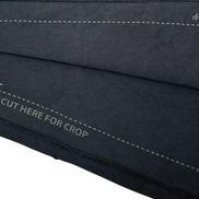 Close-up of a black fabric with stitching details on a white background