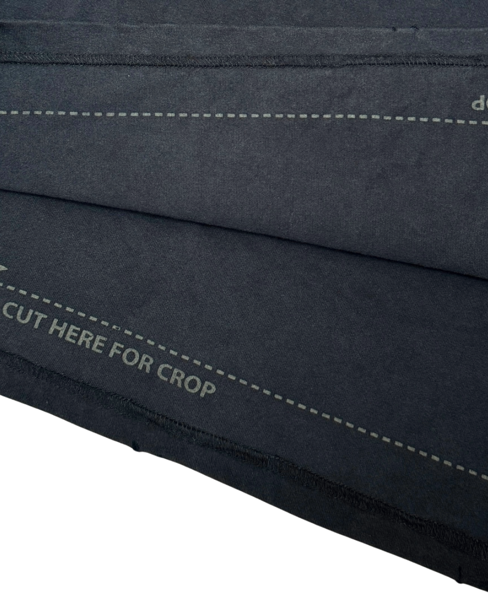 Close-up of a black fabric with stitching details on a white background