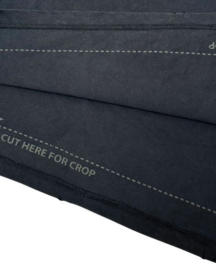 Close-up of a black fabric with stitching details on a white background