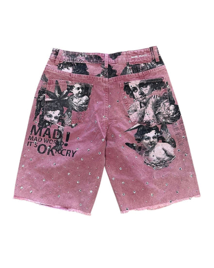 Pink shorts with graphic designs and text on a white background