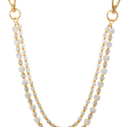 Gold and gemstone pant chain on a white background