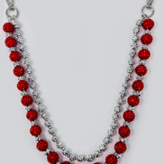Red beaded pant chain with silver accents on a white background