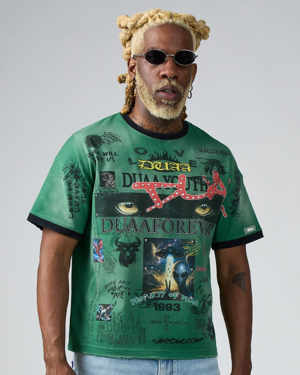 Man wearing a green t-shirt with graphic designs and text