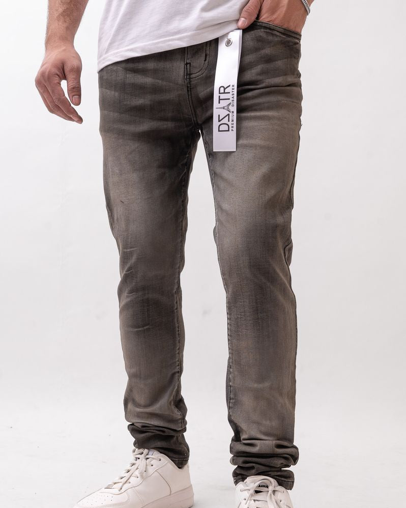 Person wearing dark gray jeans with a visible brand tag on a white background