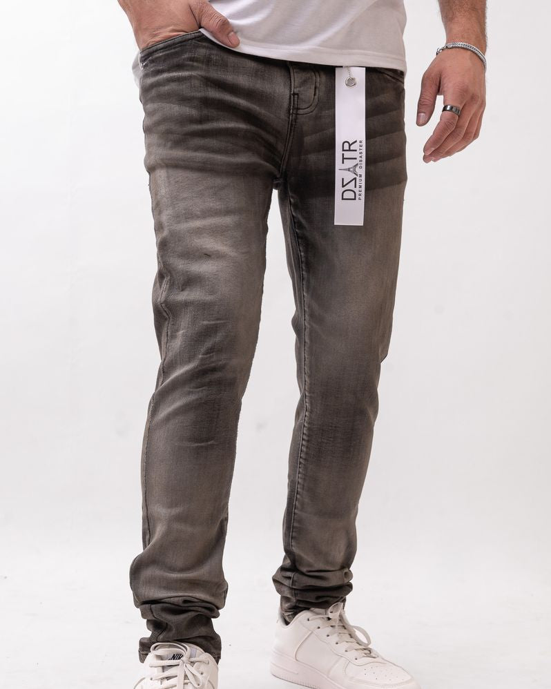 Person wearing gray jeans with a brand label on a white background