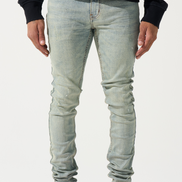 Person wearing light blue jeans and red sneakers on a white background