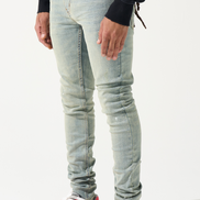 Person wearing light blue jeans and red sneakers on a white background