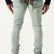 Person wearing light blue jeans and red shoes on a white background