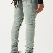 Person wearing light blue jeans and red sneakers on a white background