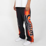 Person wearing black and orange pants with a logo on a white background