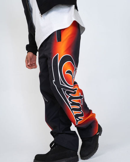 Black pants with orange and white design on a white background