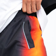 Close-up of a person wearing a jacket with a gradient design transitioning from black to orange.