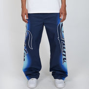 Person wearing blue sweatpants with white text on a plain background
