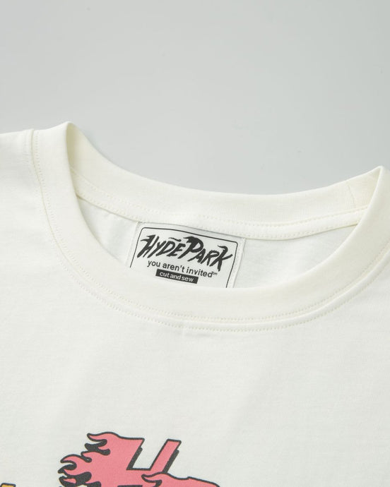 Close-up of a white t-shirt with a brand label on a gray background