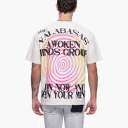 Person wearing a white t-shirt with colorful text and design on the back, on a white background