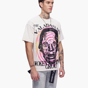 Person wearing a white t-shirt with a graphic design on a white background