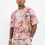 Person wearing a pink outfit with angel designs on a white background