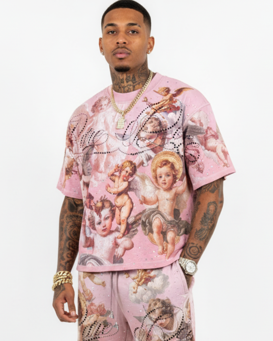 Person wearing a pink outfit with angel designs on a white background