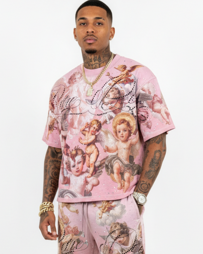 Person wearing a pink outfit with angel designs on a white background