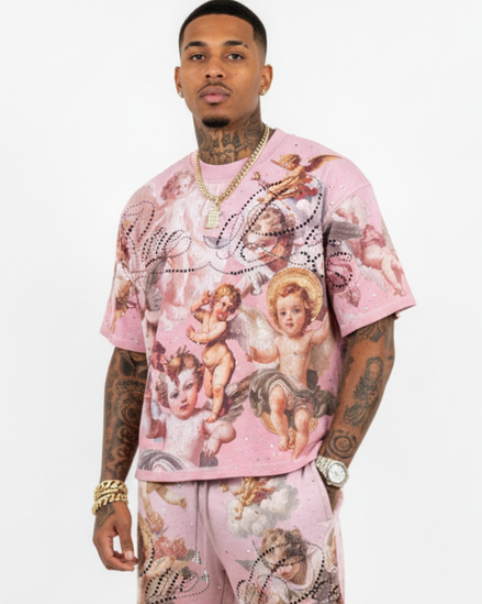 Person wearing a pink outfit with angel designs on a white background