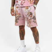 Person wearing a pink outfit with angel designs on a white background