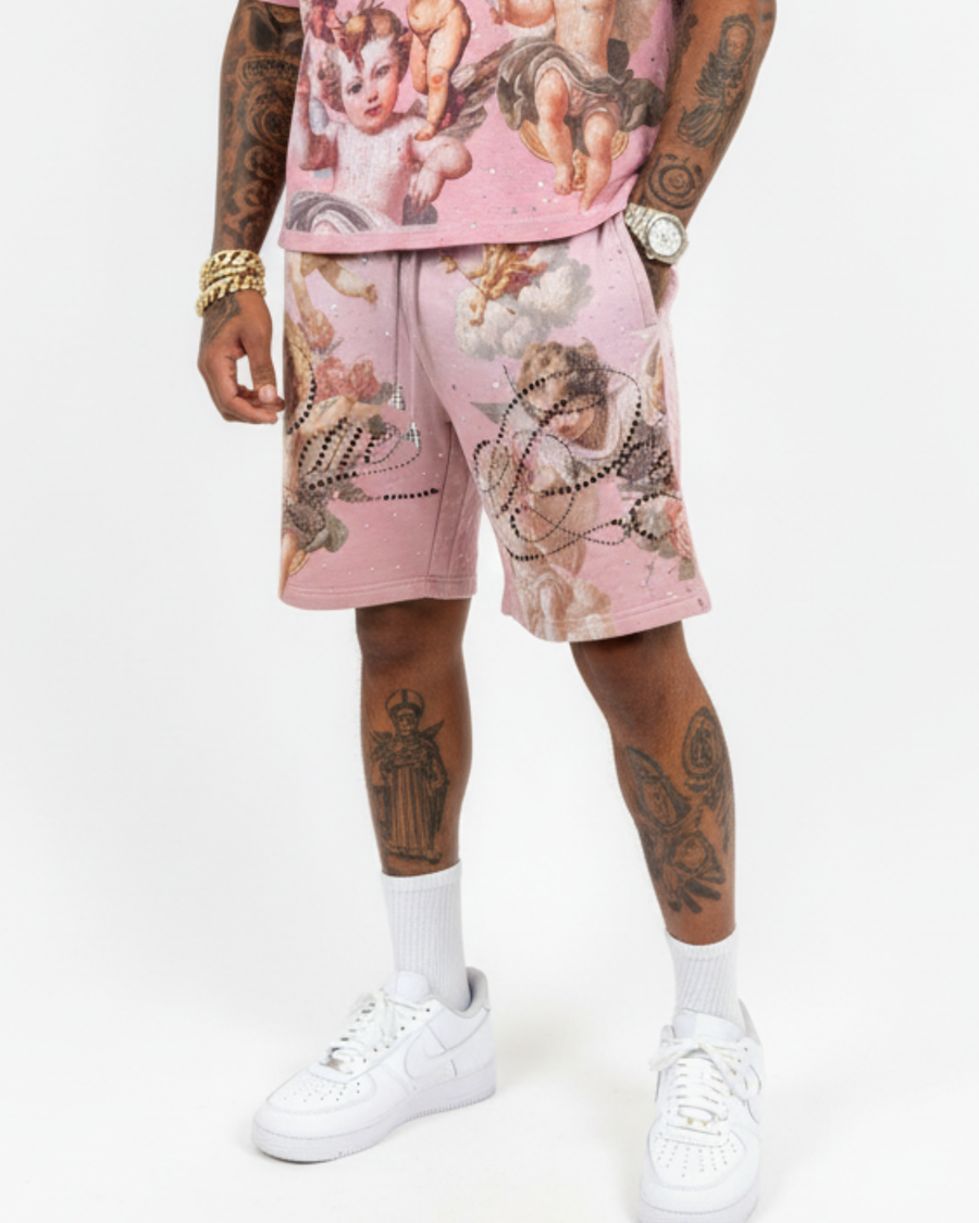 Person wearing a pink outfit with angel designs on a white background