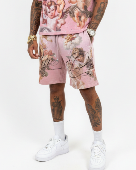 Person wearing a pink outfit with angel designs on a white background