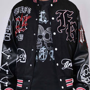 Black varsity jacket with graphic designs on a gray background