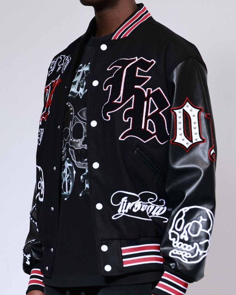 Black varsity jacket with white and red designs on a plain background