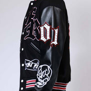 Black varsity jacket with white and red designs on a plain background