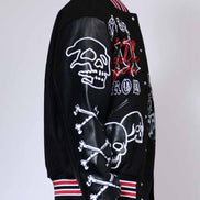 Black varsity jacket with skull and crossbones design on a white background