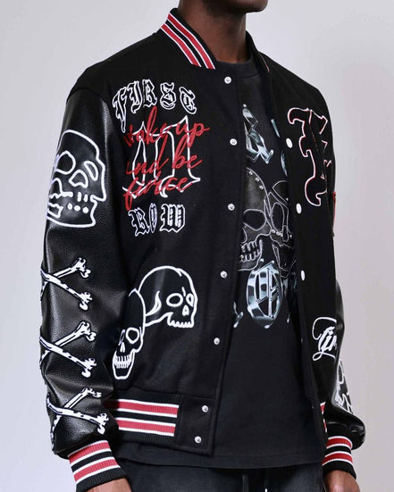 Black varsity jacket with skull and bone designs on a plain background
