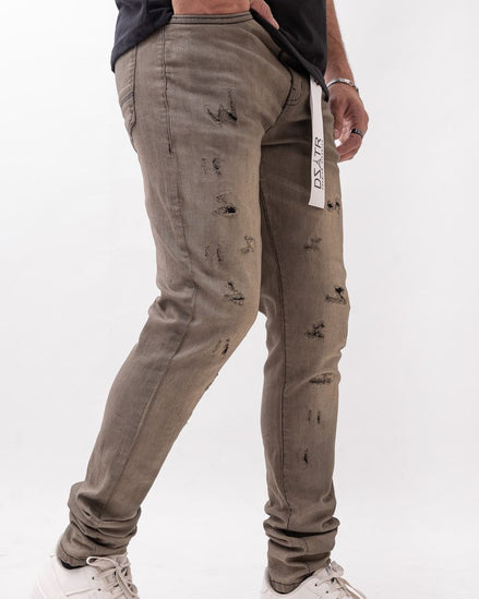 Person wearing distressed gray pants with a white background