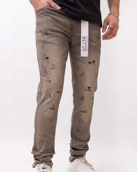Person wearing distressed gray pants with a visible brand label on a white background