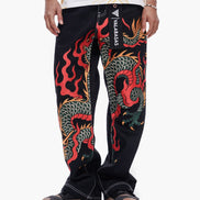 Black pants with colorful dragon design worn by a person on a white background