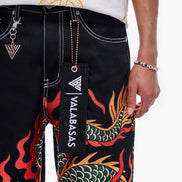 Black pants with dragon design and 'VALABASAS' branding, worn by a person.