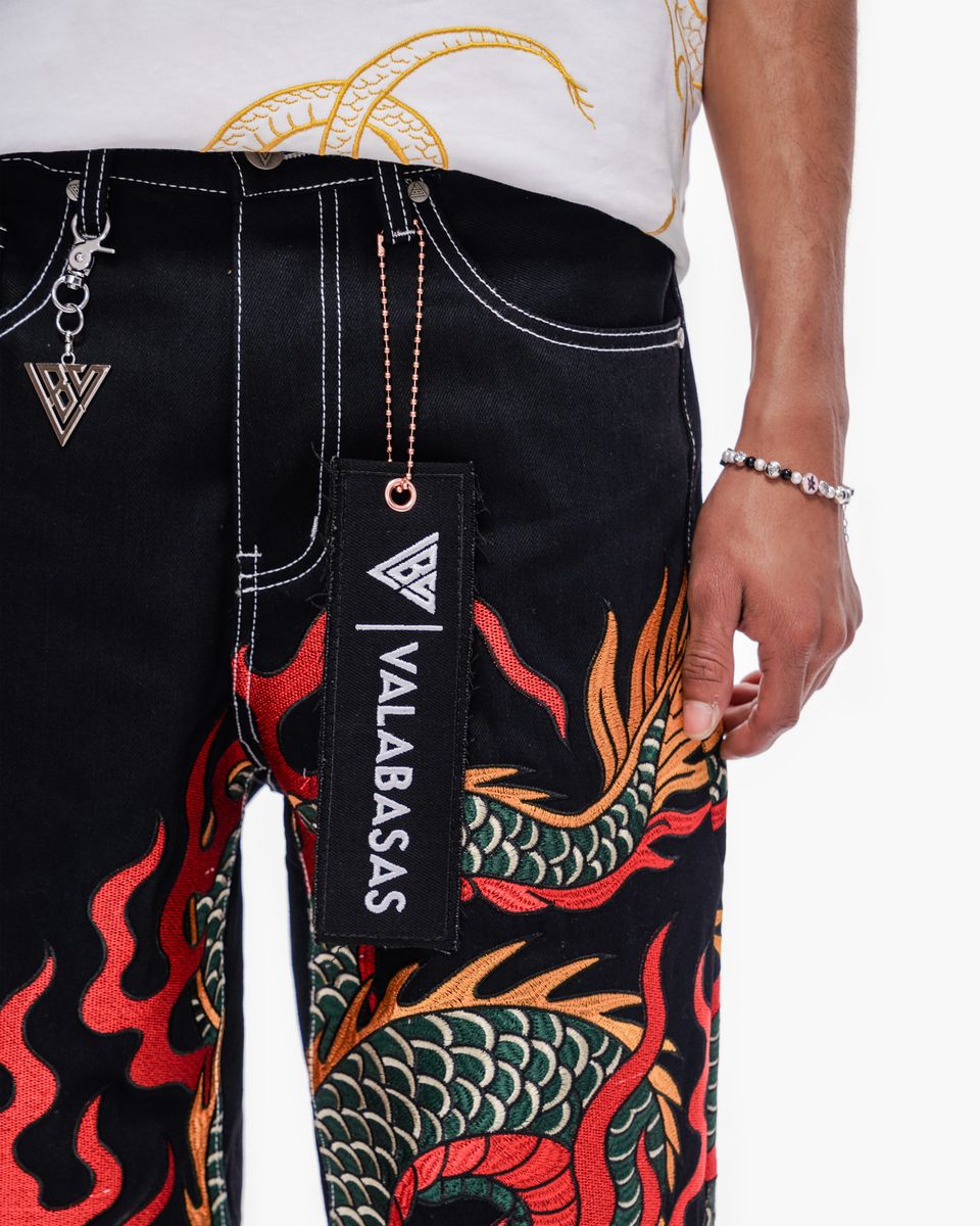 Black pants with dragon design and 'VALABASAS' branding, worn by a person.