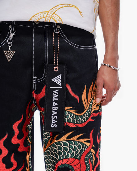 Black pants with dragon design and 'VALABASAS' branding, worn by a person.