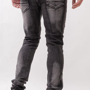 Person wearing black jeans and white sneakers on a white background