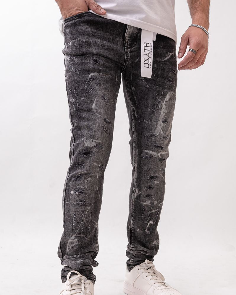 Person wearing distressed black jeans with a visible brand label on a white background