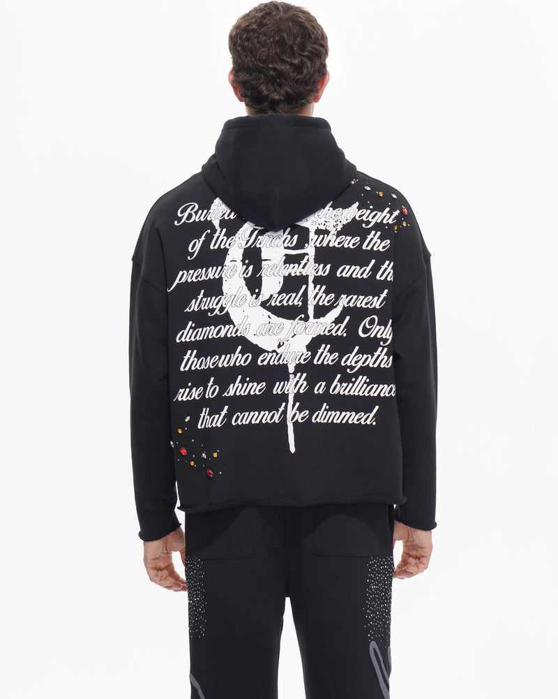 Person wearing a black jacket with white text and design on the back against a white background