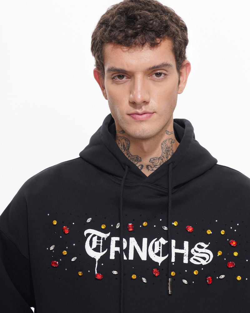 Man wearing a black hoodie with 'FINCHS' text and colorful accents on a white background