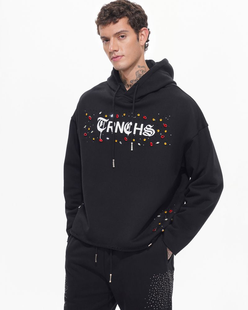 Man wearing a black hoodie with colorful text design on a white background