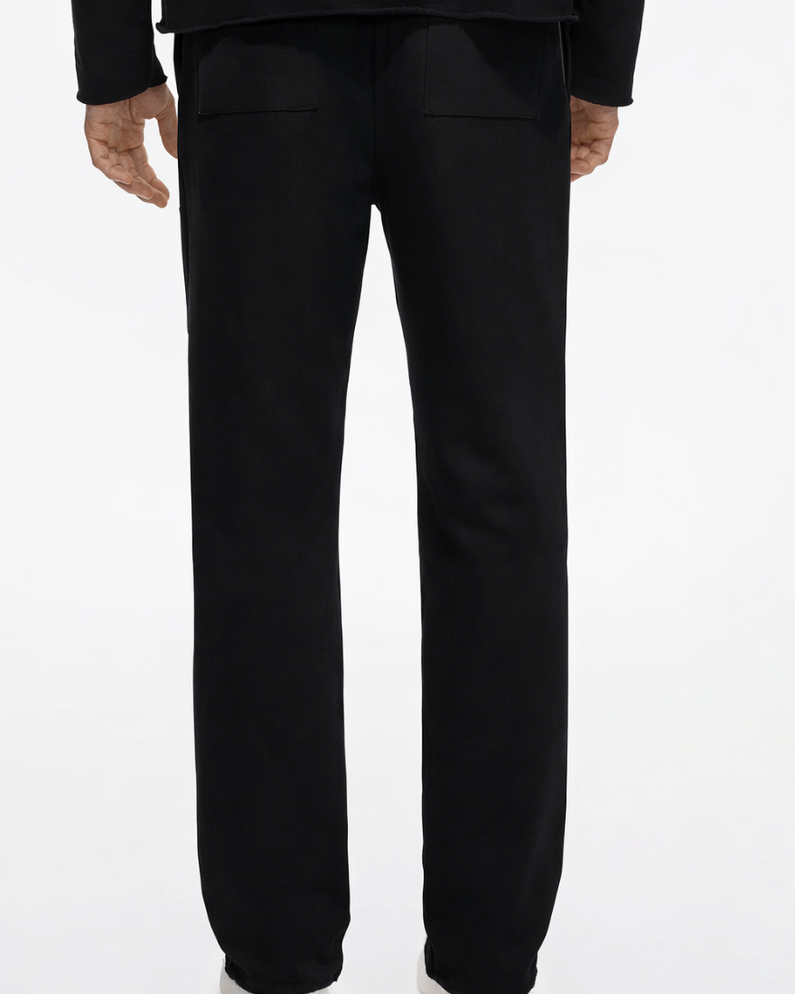 Person wearing black pants on a white background