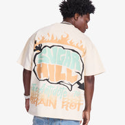 Person wearing a white t-shirt with colorful graphics and text on a plain background