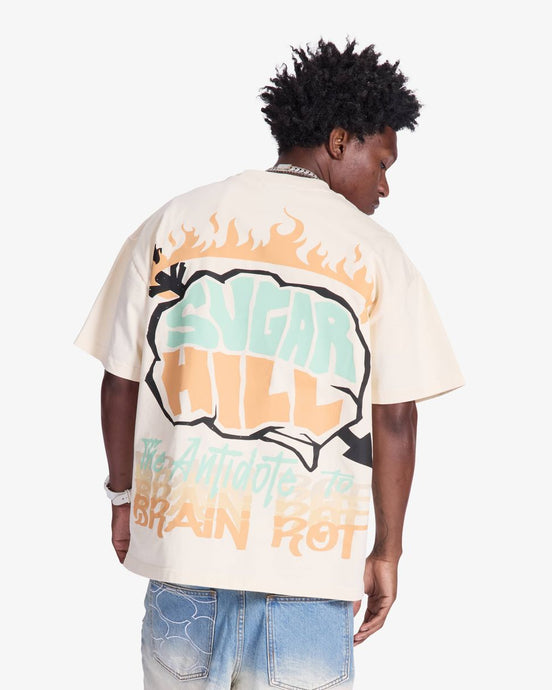 Person wearing a white t-shirt with colorful graphics and text on a plain background