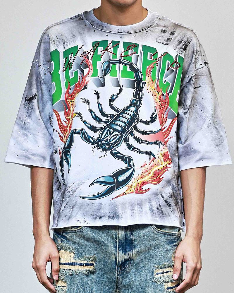 Person wearing a graphic t-shirt with a scorpion design and 'BE HAPPY' text.